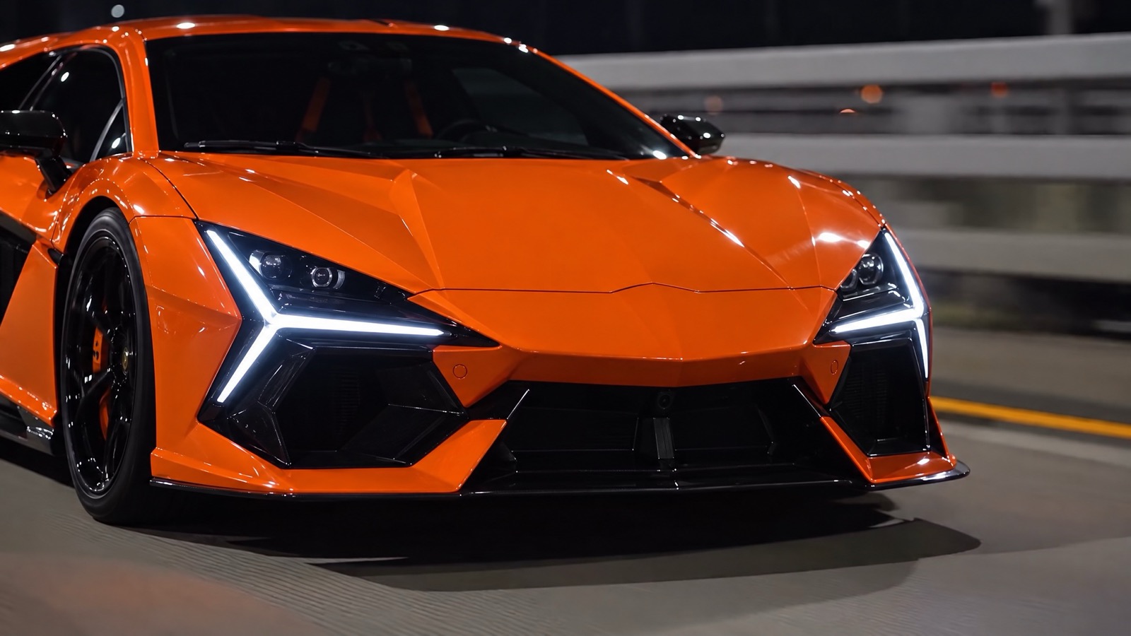 The real orange Lamborghini Revuelto from the front at night