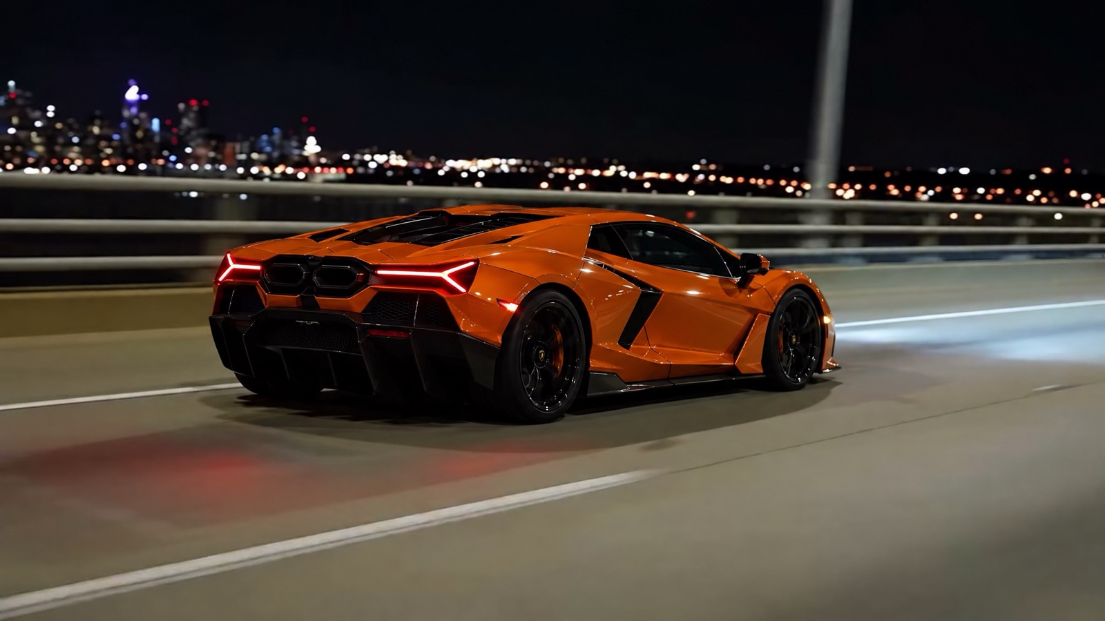 The real orange Lamborghini Revuelto from behind on a night bridge